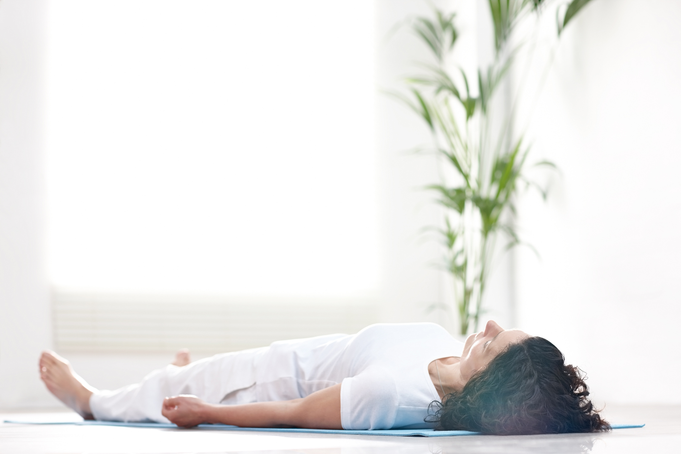 Mature woman doing savasana